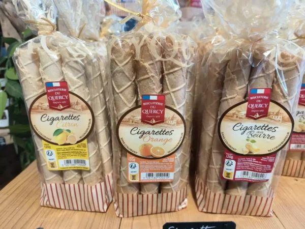 Trois paquets de Cigarettes Biscuiterie du Quercy (120g) : citron, orange, et au beurre. Sans colorant ni conservateur, fabriquées depuis 1967.
